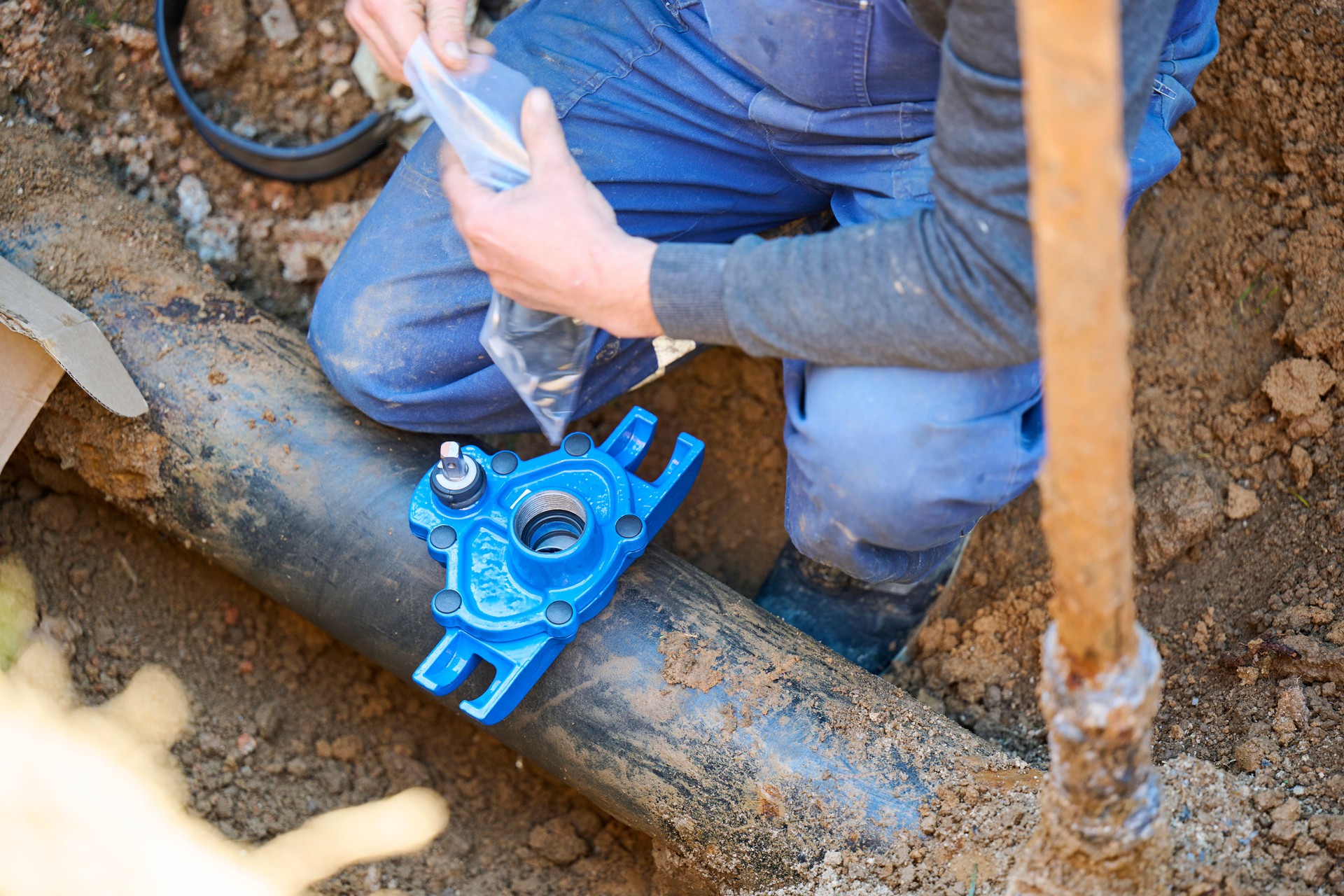 Construction worker, repairing a broken water pipe